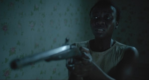 The Keeping Room holding a gun